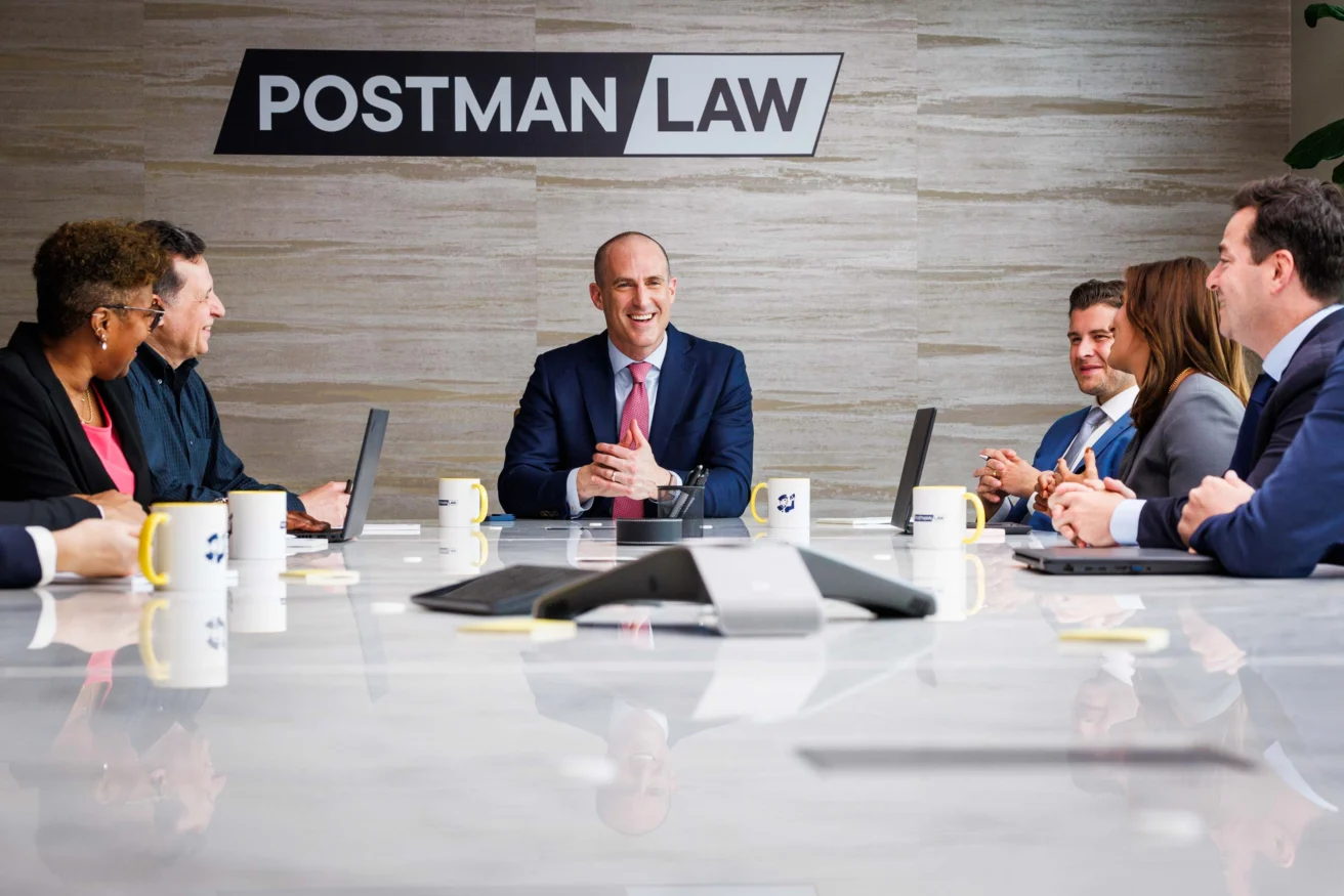 A group of lawyers in a meeting at Postman Law.