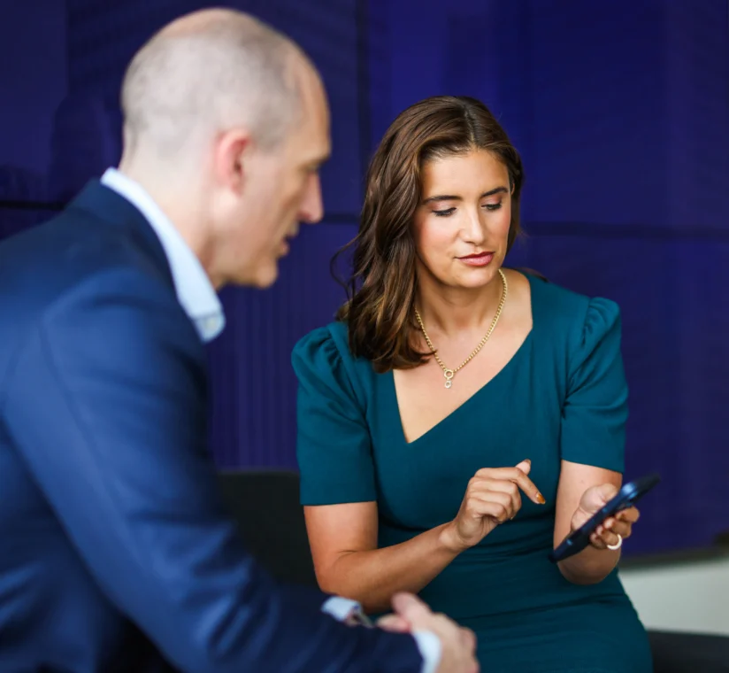 Two lawyers looking at a phone.